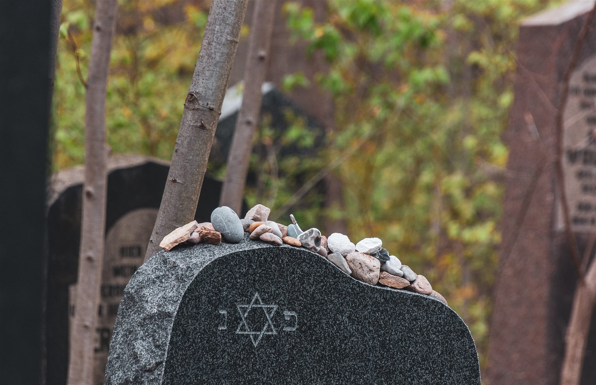 Jewish headstone with Star of David and remembrance stones